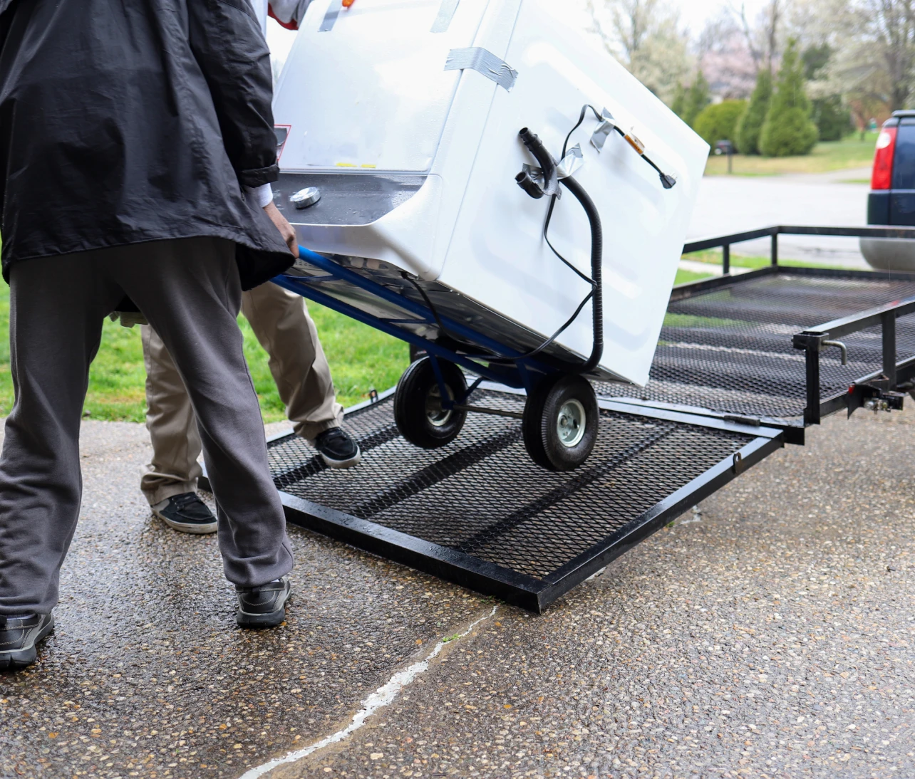 Moving a refrigerator onto a trailer.
