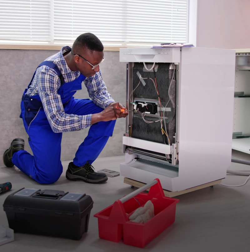 Technician repairing a washing machine.